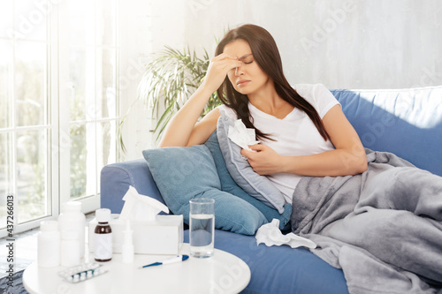 Upset female resting in bed during illness