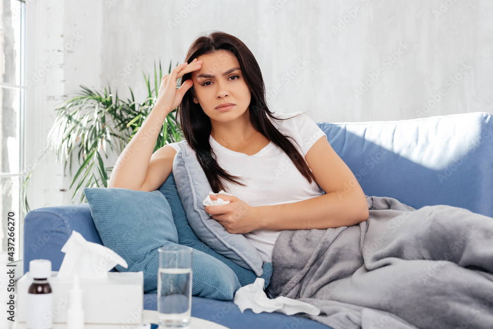 Weak young woman getting home treatment during disease Weak young woman getting home treatment during disease