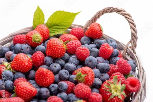 Basket with berries. Raspberries  strawberries and blueberries. Isolate