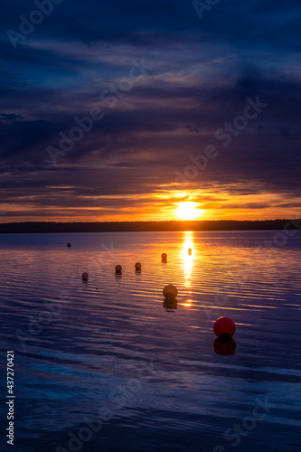 A beautiful, colorful evening scenery during sunrise at the lake. Lakeside sunset in Northern Europe.