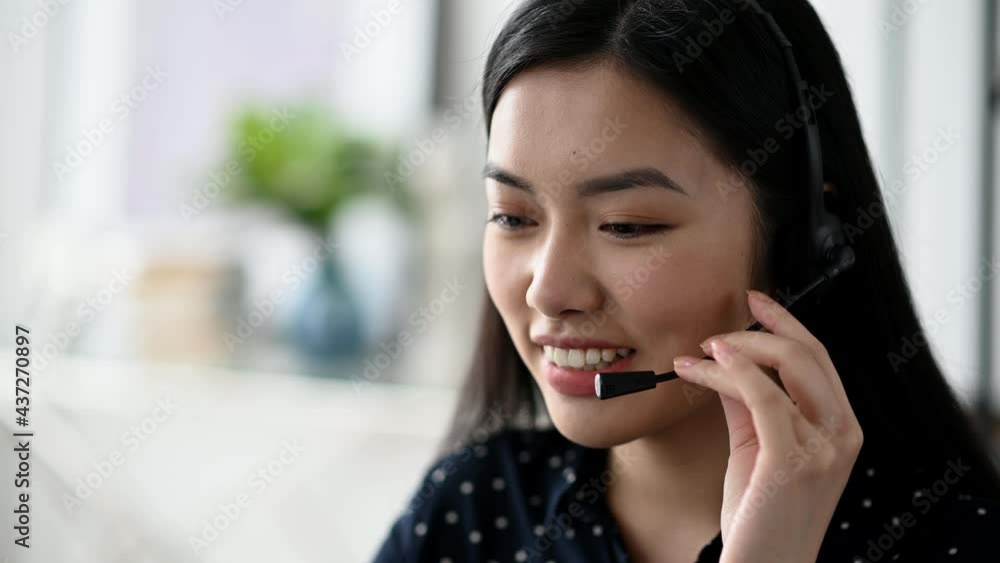 Close-up of beautiful confident long haired young asian woman in headset, freelancer, call center worker or consultant, wearing black stylish shirt, talks via online communication, smiling friendly Close-up of beautiful confident long haired young asian woman in headset, freelancer, call center worker or consultant, wearing black stylish shirt, talks via online communication, smiling friendly