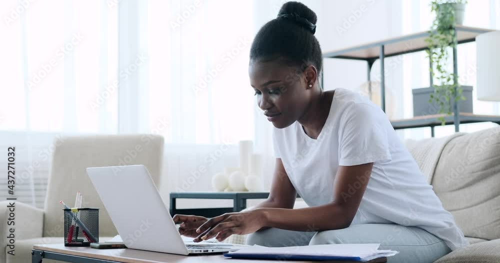African american woman working on laptop at home African american woman working on laptop at home