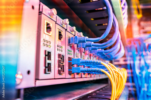 Fiber Optical cables connected to an optic ports and Network cables connected to ethernet ports photo