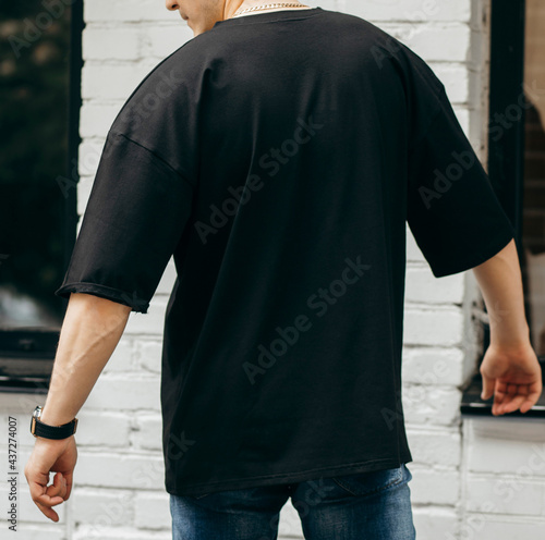 Man wearing black blank t-shirt with space for your logo or design. Mock up