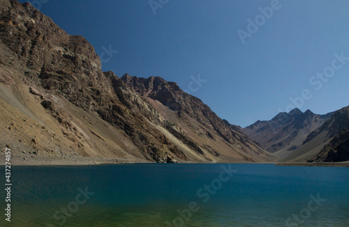 Alpine landscape. The glacier water lake in the cordillera in a summer sunny day. View of the turquoise color lake called Inca Lagoon high in the Andes mountain range in Portillo, Chile.