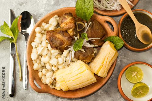 Chicharrón de chancho con mote y yuca, comida peruana vista cenital en fondo gris  photo