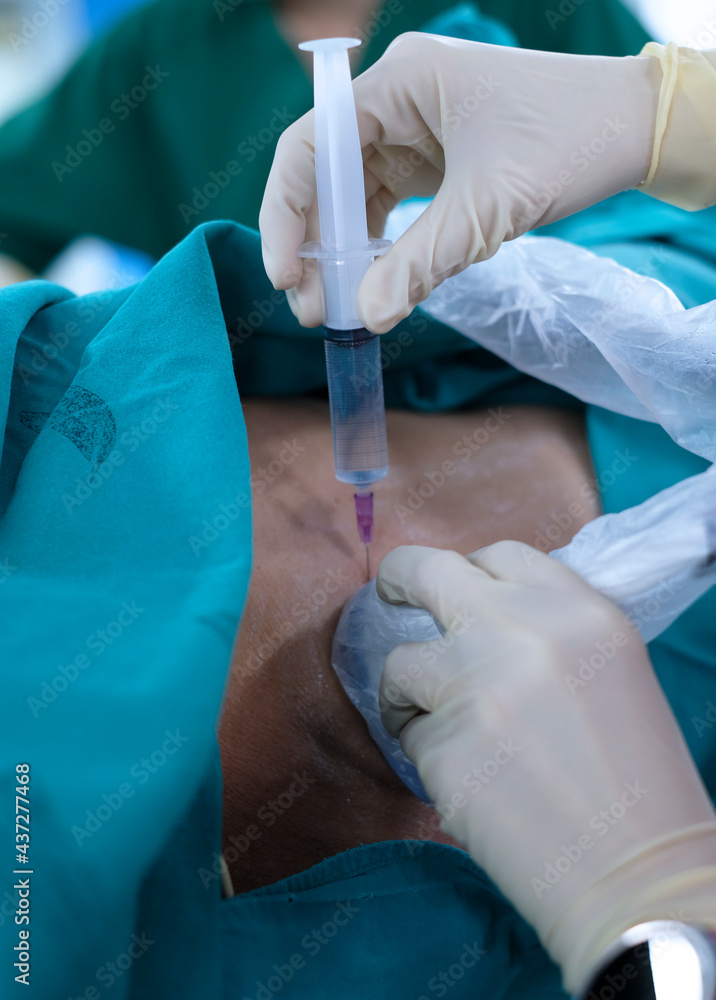 Anesthetist press ultrasound probe and injection more medication on the ...