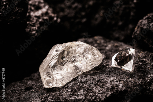rough diamond and cut diamond in coal mine, mining concept and rare gemstone photo