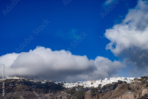 View of clouds above Imerovigly from sea. Santorini island, Greece. © Anastasia