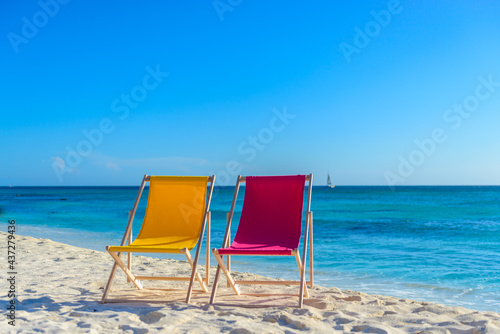 Beach chairs with beach bag on the shoreline at sunset  beautiful beach