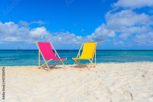 Fototapeta Naklejka Na Ścianę i Meble -  Beach chairs on the shoreline, beautiful beach