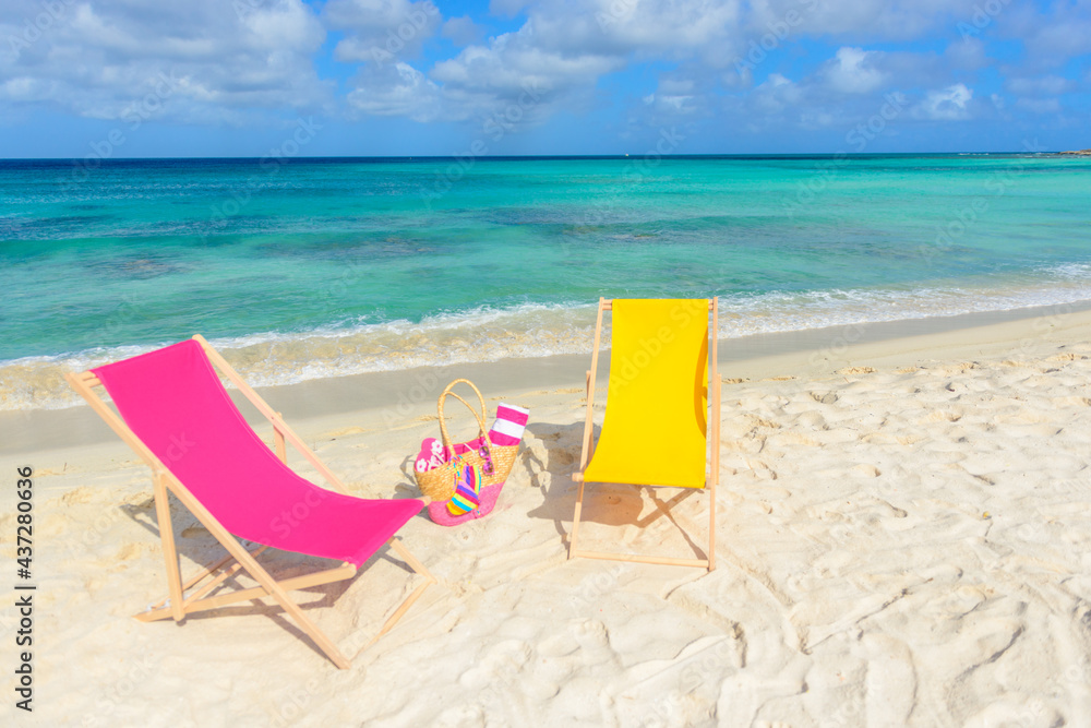 Beach chairs, beach bag, flip flops, beach towel on the shoreline, beautiful beach Beach chairs, beach bag, flip flops, beach towel on the shoreline, beautiful beach