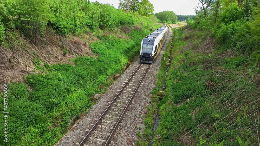 Passenger train in the gorge. Green landscape in Lower Silesia area. Beautiful spring in Poland. Passenger train in the gorge. Green landscape in Lower Silesia area. Beautiful spring in Poland.