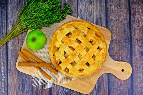 Homemade delicious apple pie on wooden tray.
