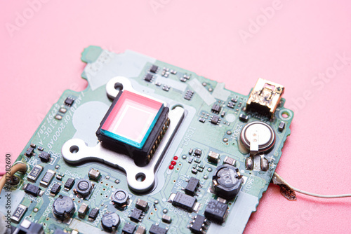 Electronic circuit board on pink background