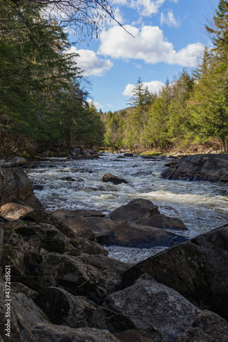 The gorgeous Sacandaga River with an expansive blue sky on a spring day.