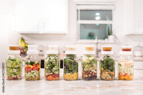 Fresh Meal Prep Salads Layered in Jars on Kitchen Counter