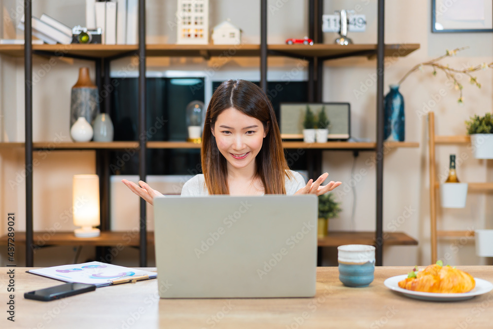 Asian woman using laptop making video call for distant meeting or online support working from home while coronavirus pandemic Asian woman using laptop making video call for distant meeting or online support working from home while coronavirus pandemic