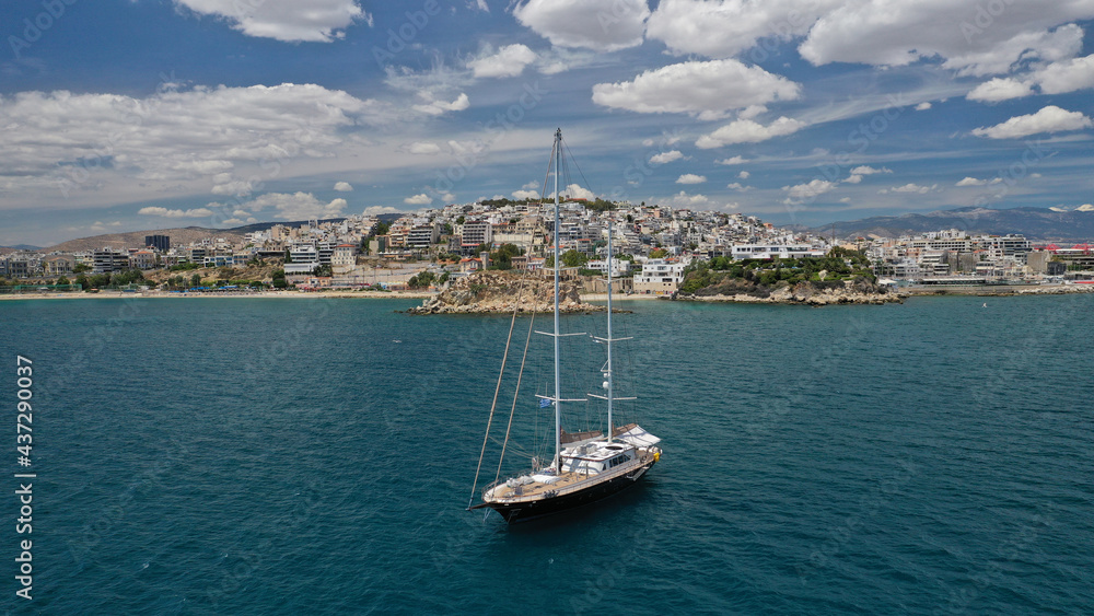 Aerial drone photo of beautiful sail boat anchored near small port of Mikrolimano in Piraeus, Attica, Greece