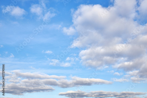 Natural daylight and white clouds floating across a blue sky