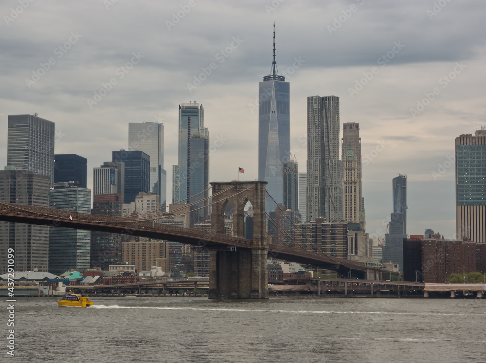Cityscape of Manhattan with high rise buildings and the Brooklyn bridge in New York City