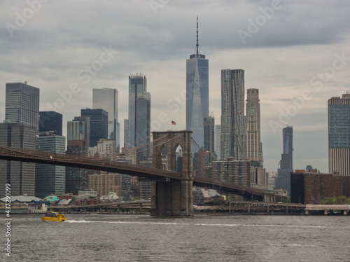 Cityscape of Manhattan with high rise buildings and the Brooklyn bridge in New York City © Galdric