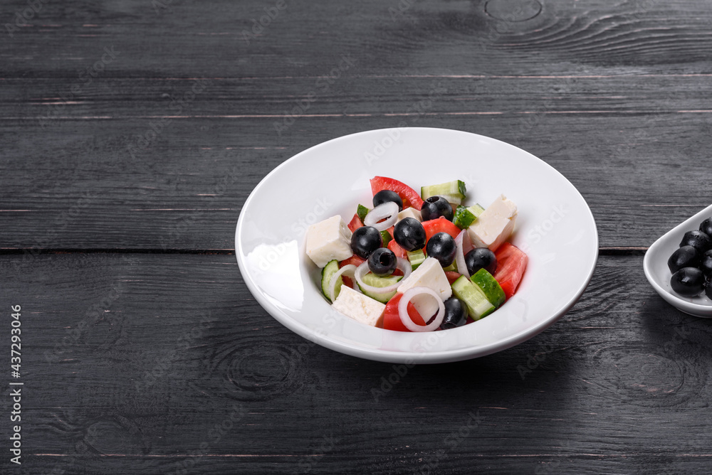 Fresh delicious Greek salad with tomato, cucumber, onions and olives with olive oil Fresh delicious Greek salad with tomato, cucumber, onions and olives with olive oil