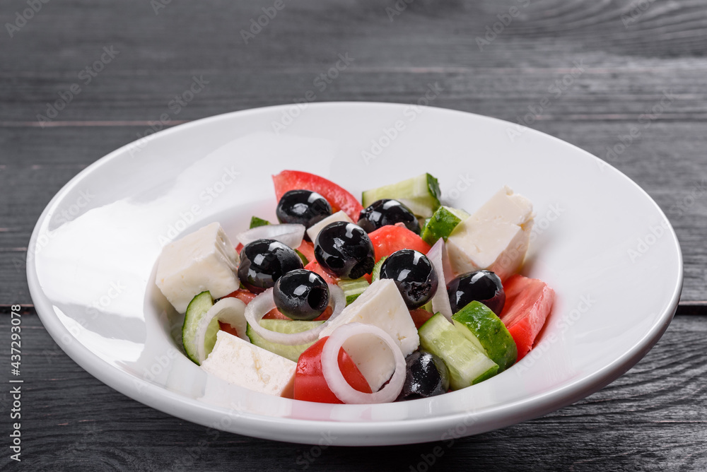 Fresh delicious Greek salad with tomato, cucumber, onions and olives with olive oil