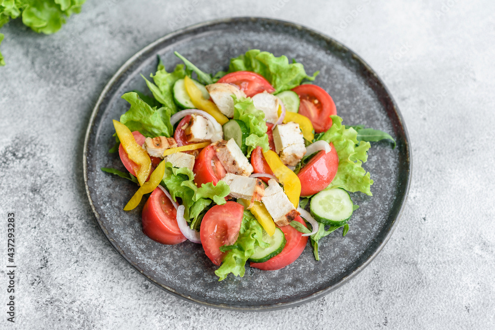Fresh delicious salad with chicken, tomato, cucumber, onions and greens with olive oil Fresh delicious salad with chicken, tomato, cucumber, onions and greens with olive oil