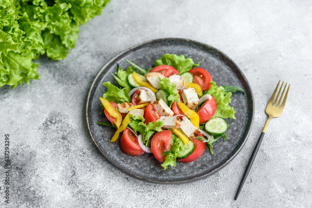 Fresh delicious salad with chicken, tomato, cucumber, onions and greens with olive oil Fresh delicious salad with chicken, tomato, cucumber, onions and greens with olive oil