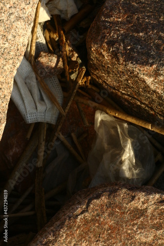 Garbage on the shore, medical mask and polyethylene