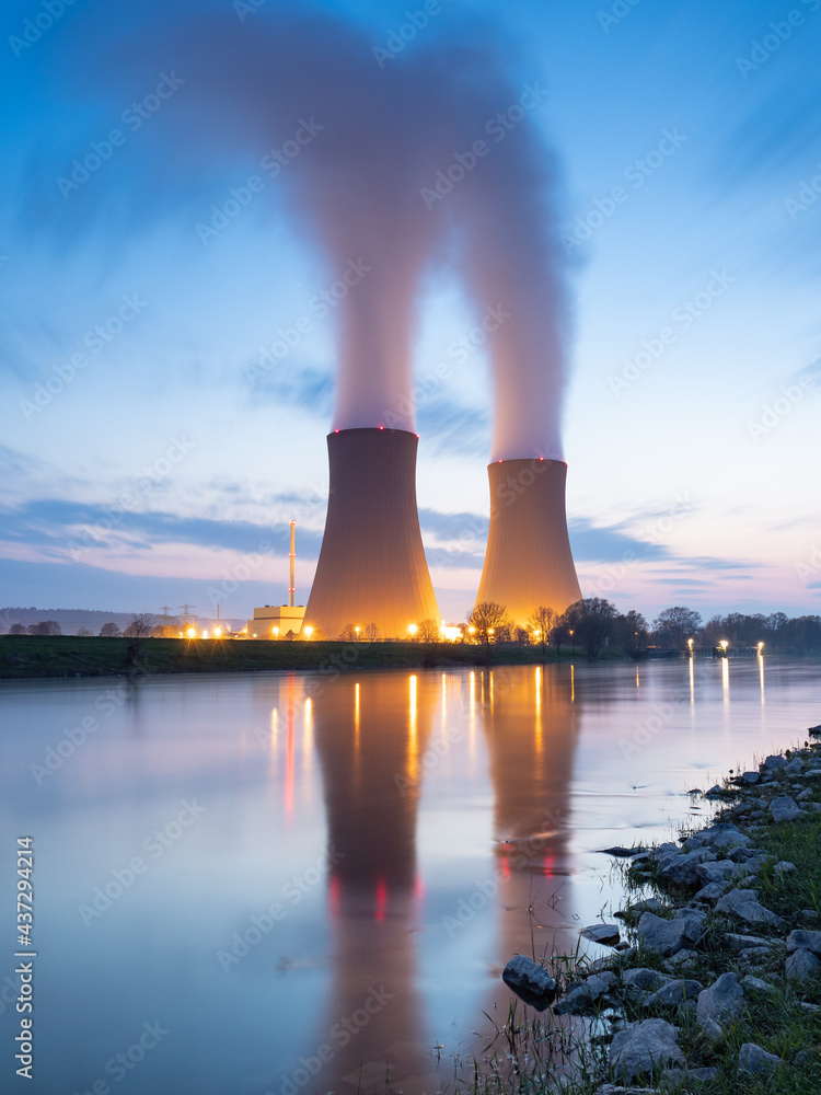 Nuclear power plant against sky by the river at sunset - obrazy, fototapety, plakaty 