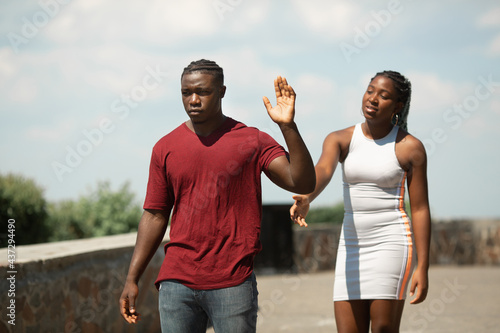  quarrel between a man and a woman in a summer park 