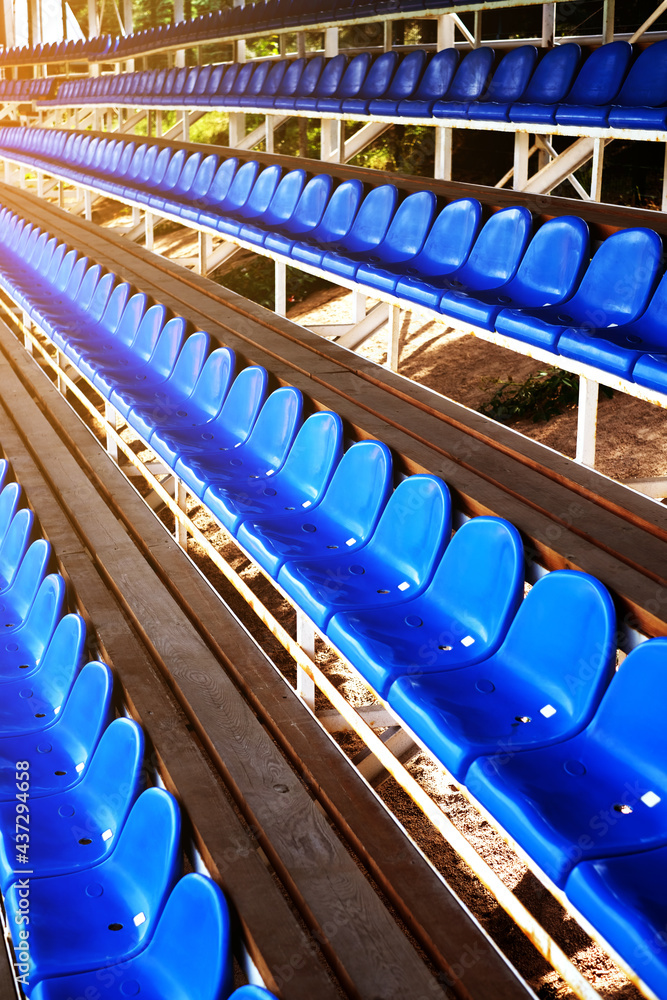Fototapeta premium blue plastic seats in the sports arena. chairs on the football field. arena