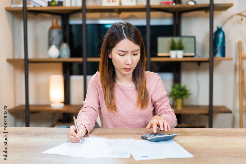 frustrated Asian woman looking at the paper bills upset throwing crumpled paper away. mental problems, failure reaction frustrated Asian woman looking at the paper bills upset throwing crumpled paper away. mental problems, failure reaction