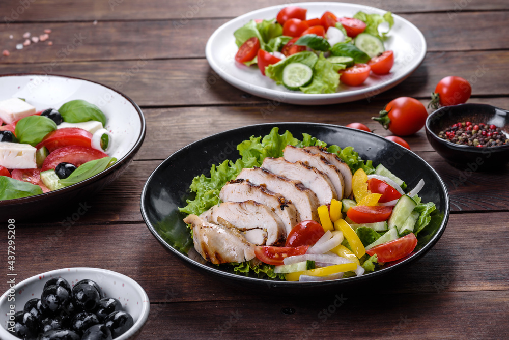 Plakat Fresh delicious salad with chicken, tomato, cucumber, onions and greens with olive oil