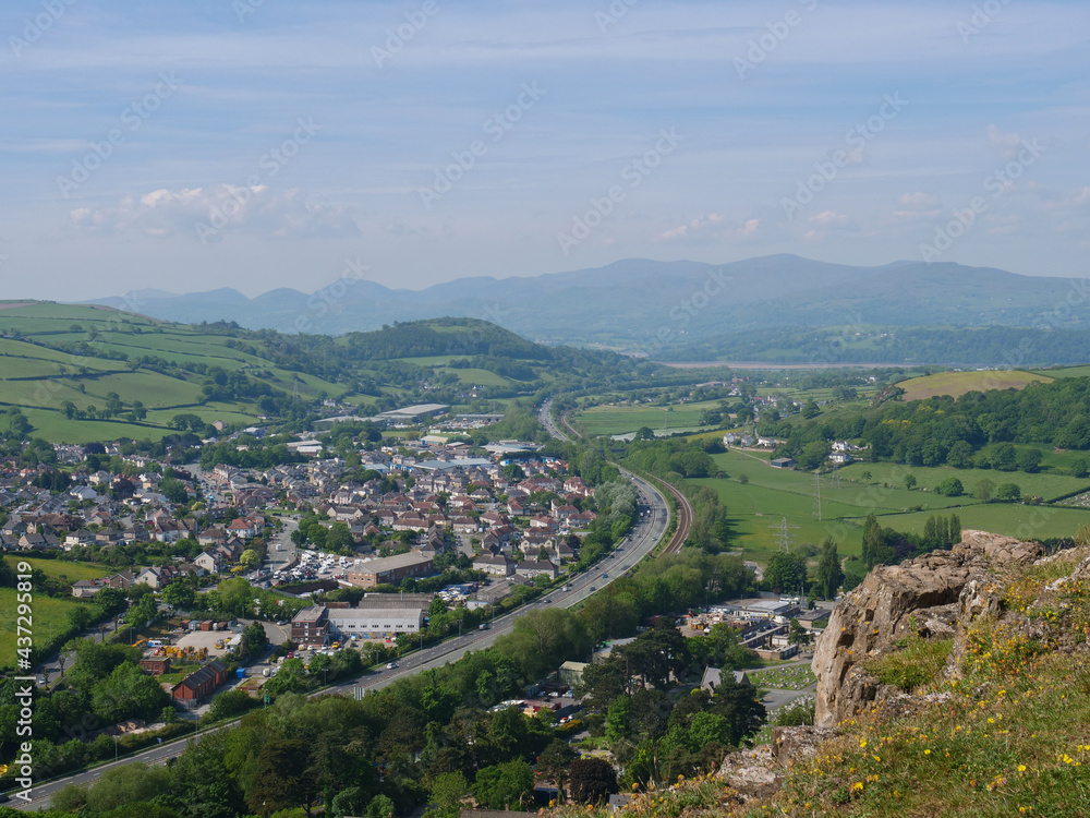 Cars driving on Welsh A55 motorway by Mochdre village and Snowdonia mountains view from cliff