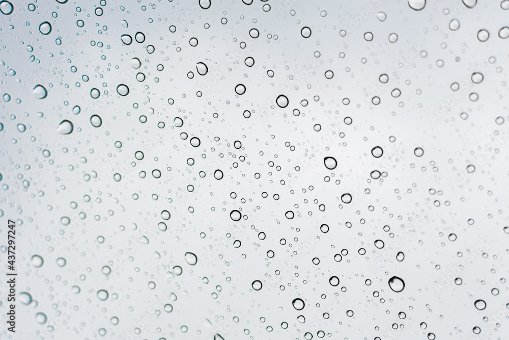 Raindrops on a transparent surface. Transparent drops of water on glass.