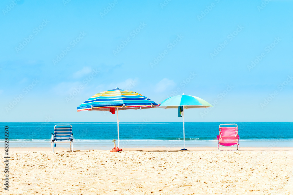 Quiet beach with umbrellas and chairs. Selective focus