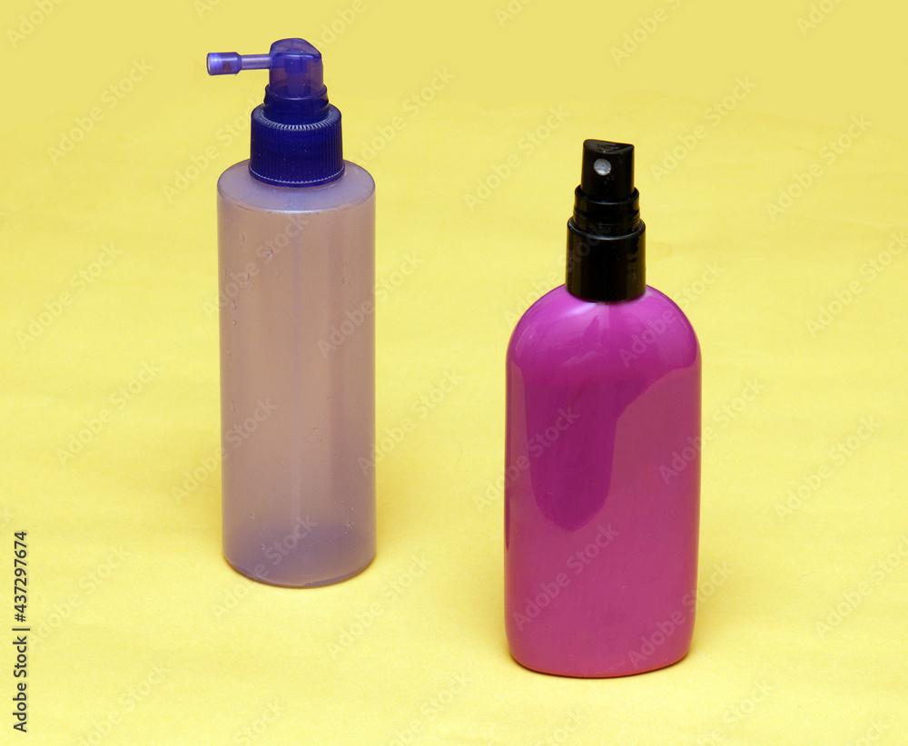 Colorful toiletries sprays on yellow Colorful toiletries sprays on yellow