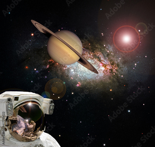 Astronaut and Saturn. Fascinating dark space. The elements of this image furnished by NASA.