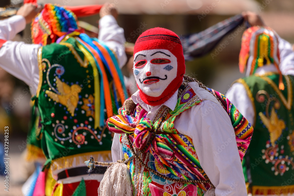 Peruvian folkloric dance, with colorful costumes in front of The Church of San Pedro Apostle of Andahuaylillas, Quispicanchi, near Cusco, Peru on October 7, 2014.