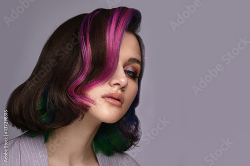 Fototapeta Naklejka Na Ścianę i Meble -  Beautiful woman with multi-colored hair and classic make up and hairstyle. Beauty face.