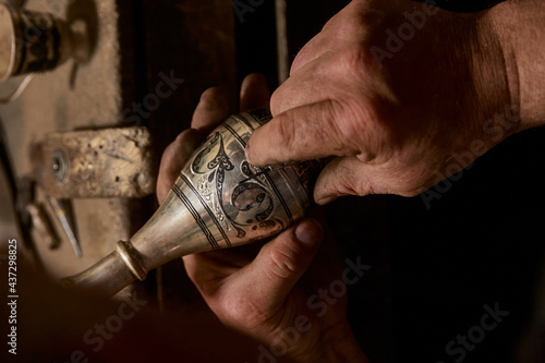 Silver making, handicraft, chasing and nielloing. Traditional work in the mountain village of Kubachi, Dagestan. photo