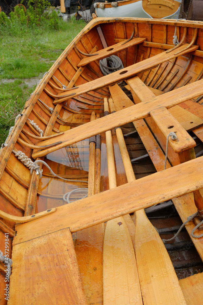 Beautiful handcrafted rowboat sitting in the rain Beautiful handcrafted rowboat sitting in the rain