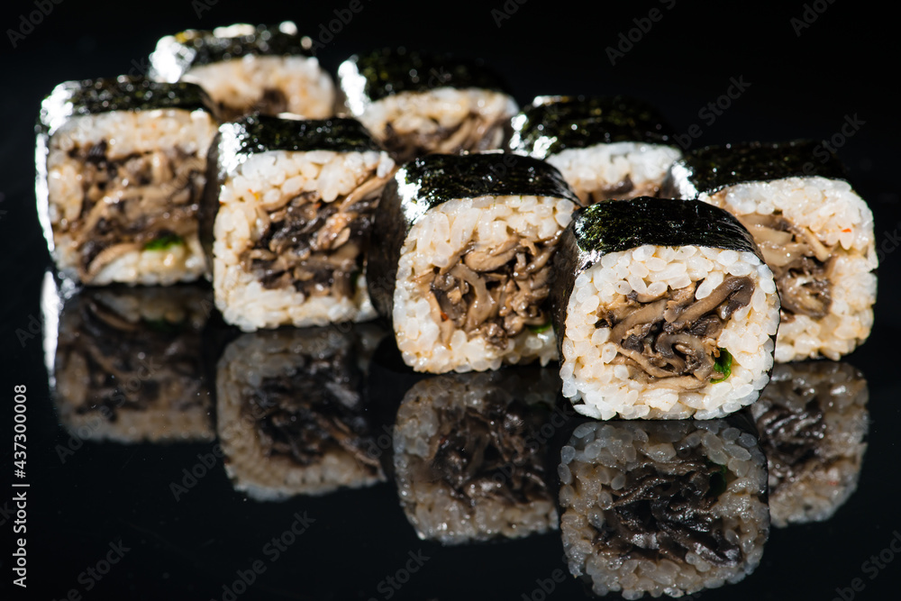 Japanese cuisine. Appetizing maki sushi rolls with rice, mushroo
