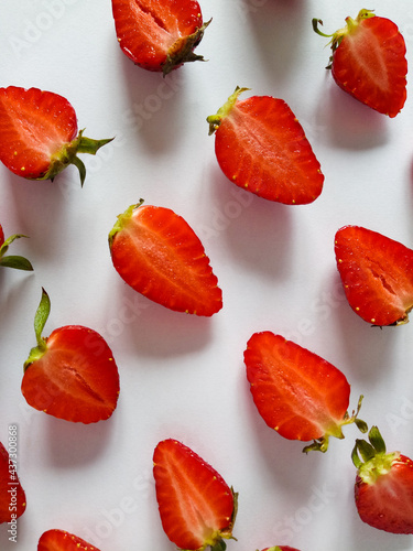 Fototapeta Naklejka Na Ścianę i Meble -  strawberries cut in half on a white background