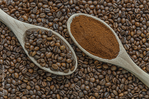 coffee beans and ground coffee on wooden spoons