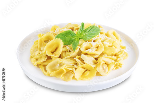 Fresh prepared Tortellini pasta with basil on a white isolated background