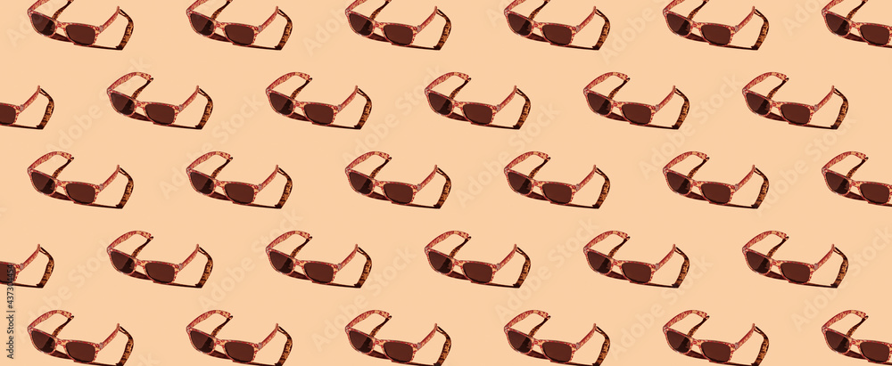 Pattern of sunglasses on orange background Pattern of sunglasses on orange background